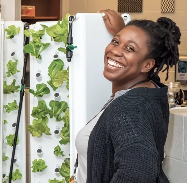 Woman Smiling in Front of Flex Farm